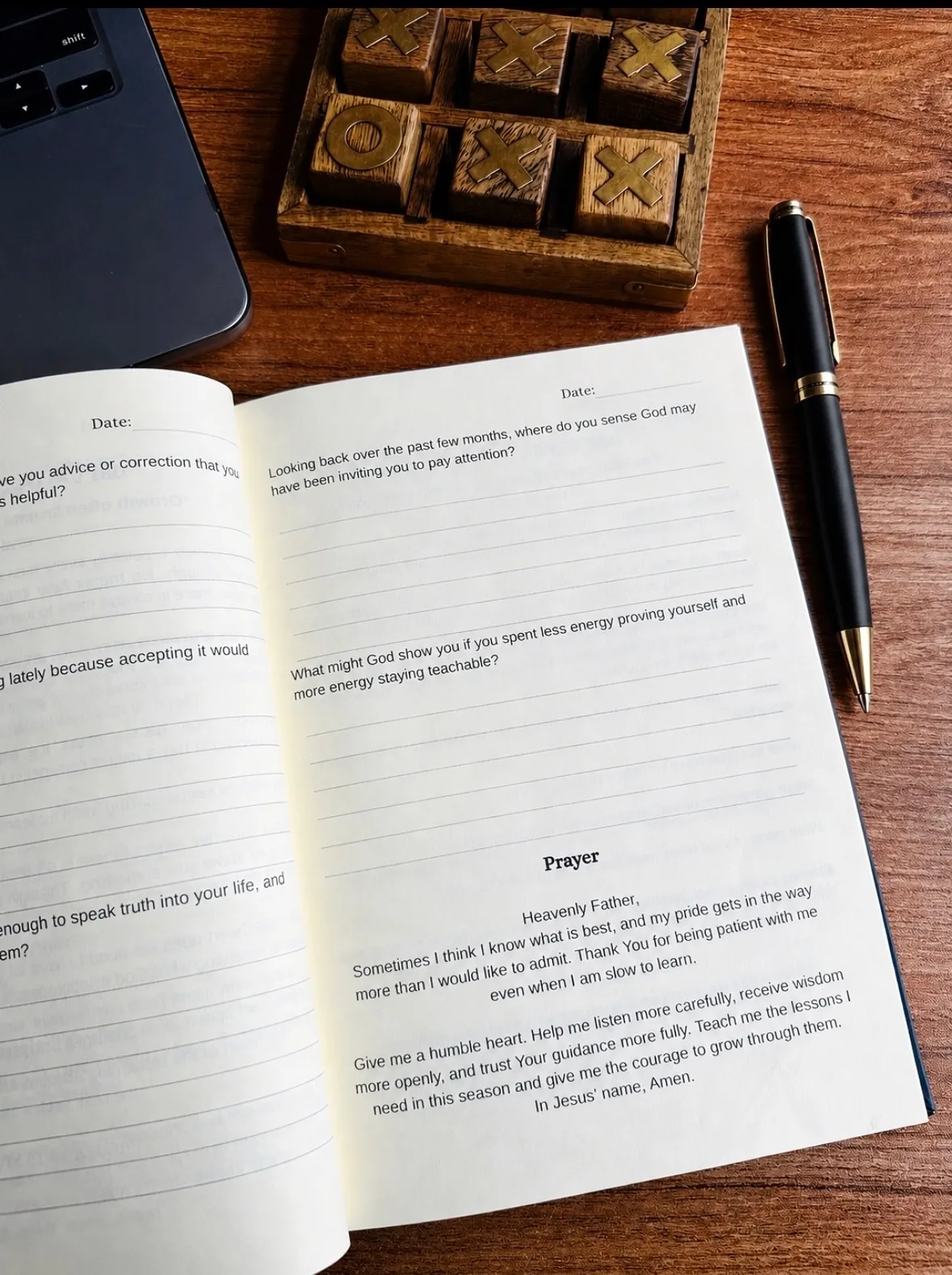 Open journal and pen on a wooden desk